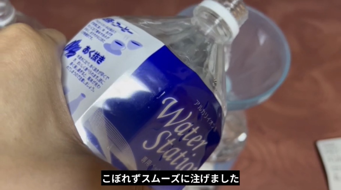 固定したじょうごを使い水をこぼさず移し替えた様子